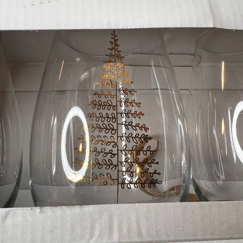 Crate & Barrel boxed set of 4 stemless wine glasses featuring a holiday tree des
